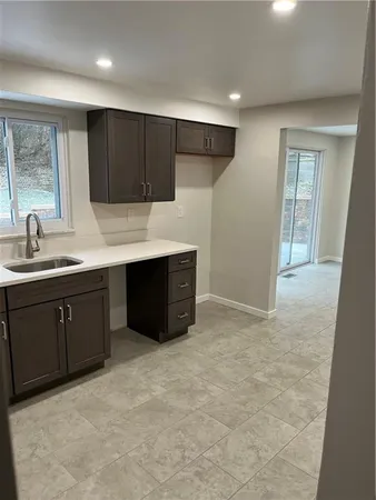 a kitchen with a sink and cabinets