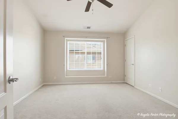 an empty room with a ceiling fan