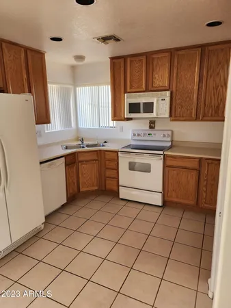 a kitchen with stainless steel appliances granite countertop a stove sink and cabinets
