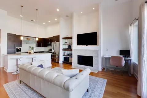 a living room with furniture fireplace and flat screen tv