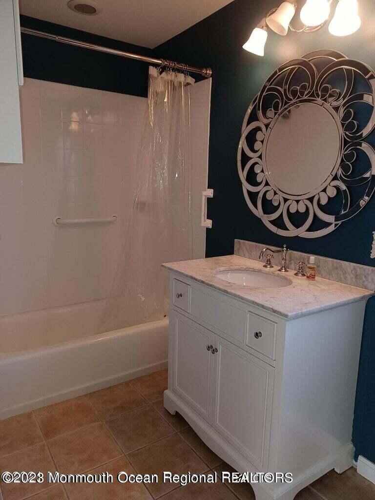 32 Eisele Avenue Asbury Park, NJ 07712 - Photo 11 of 16 a bathroom with a sink a mirror and a toilet
