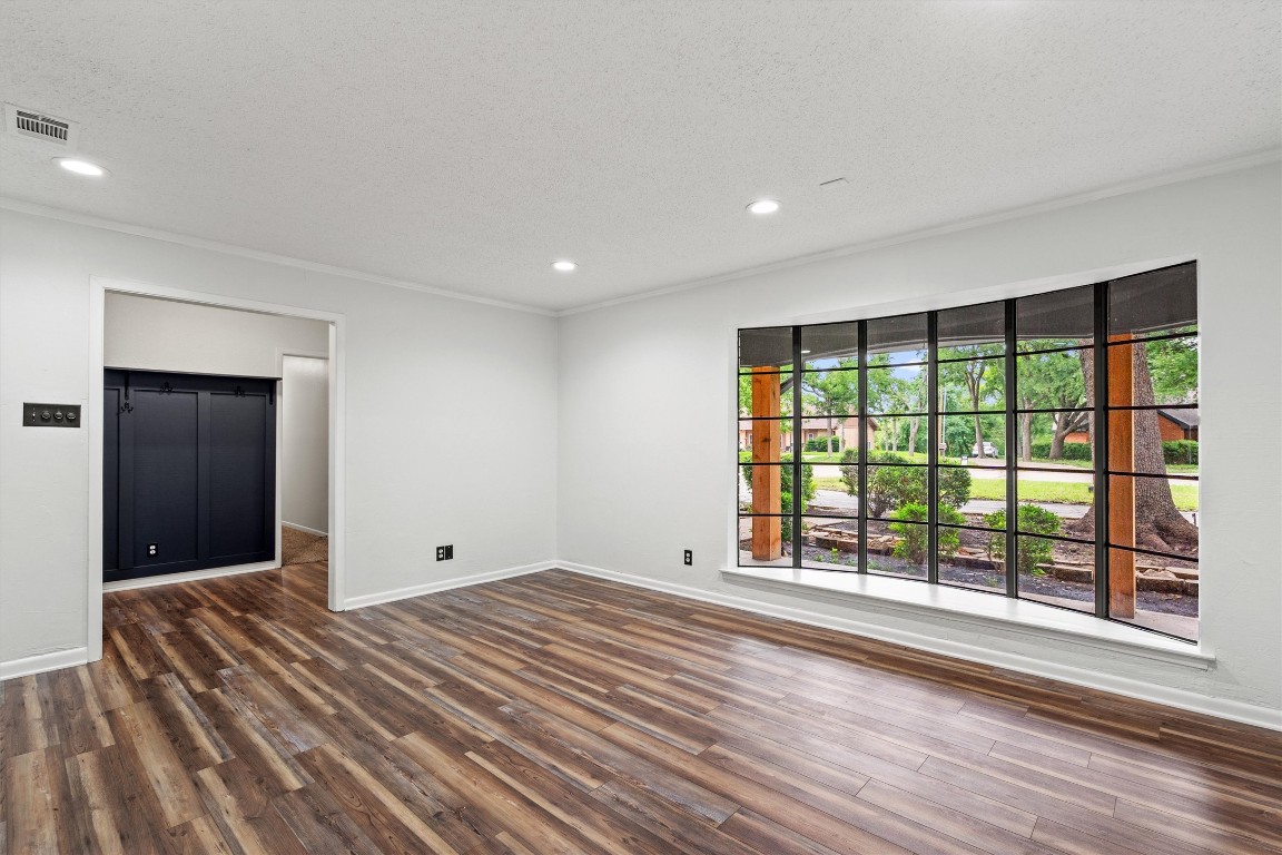 4101 Briar Cliff Road Temple, TX 76502 - Photo 4 of 40 a view of an empty room with wooden floor and a window