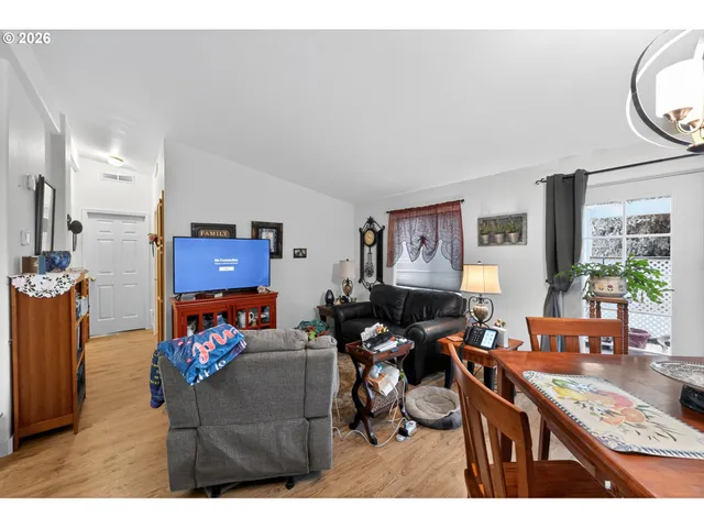 a living room with furniture a window and a flat screen tv