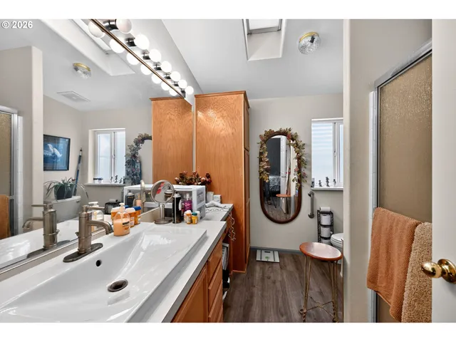 a bathroom with a tub sink and mirror