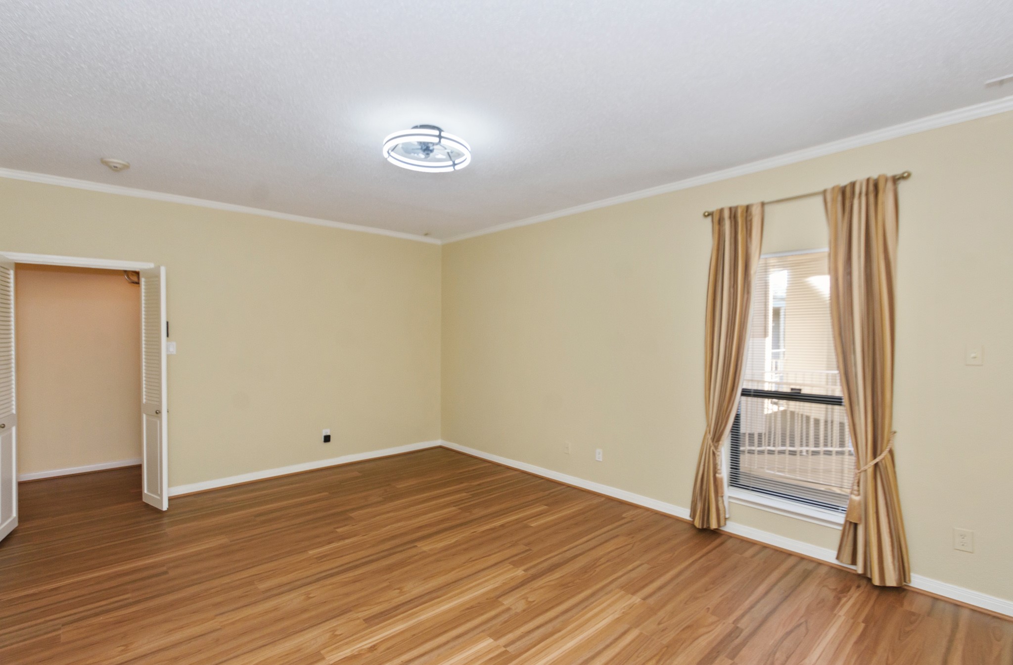351 Lakeside Lane, Unit 305 Nassau Bay, TX 77058 - Photo 17 of 32 an empty room with wooden floor and windows