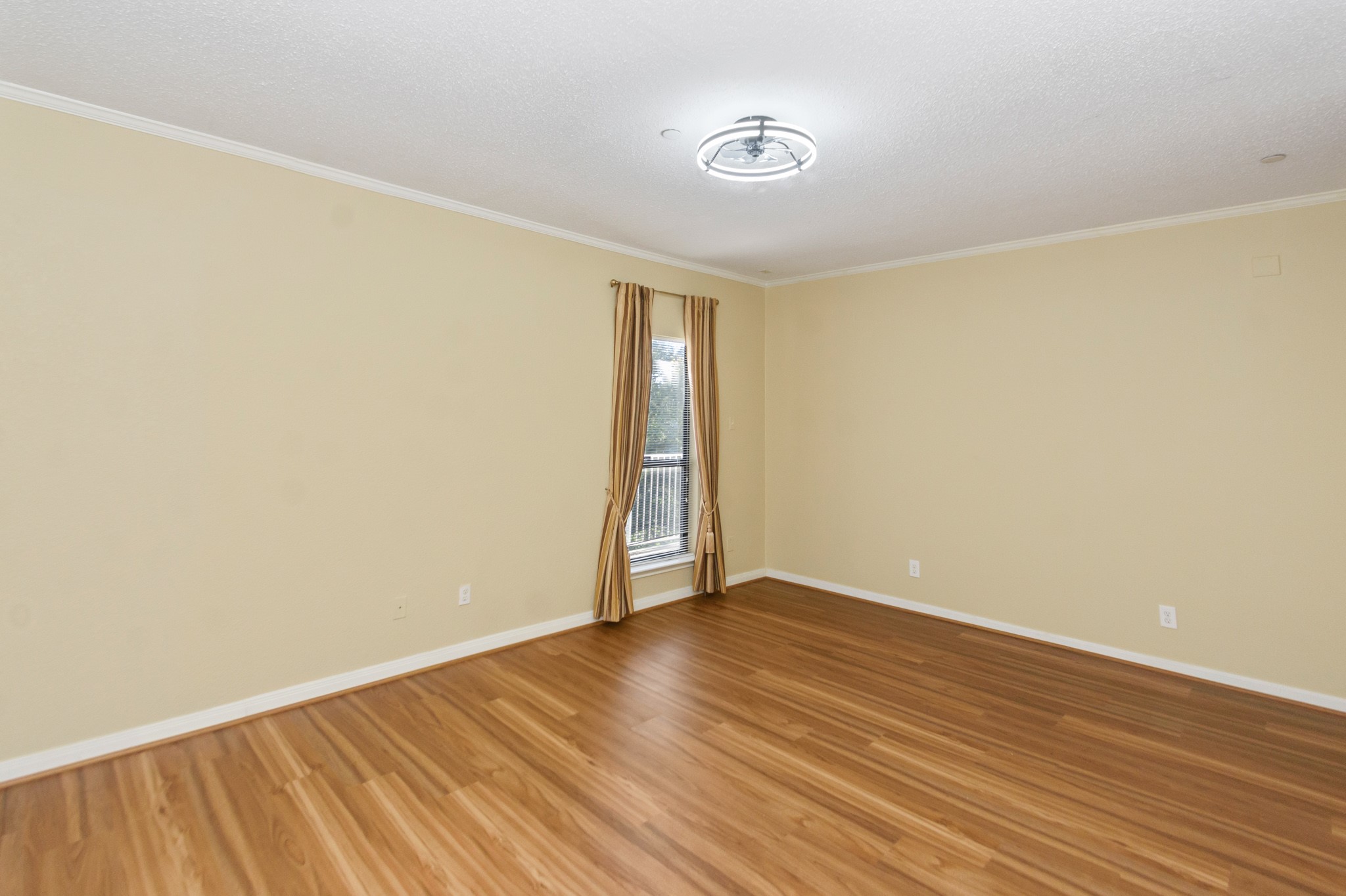 351 Lakeside Lane, Unit 305 Nassau Bay, TX 77058 - Photo 18 of 32 a view of an empty room with wooden floor and a window