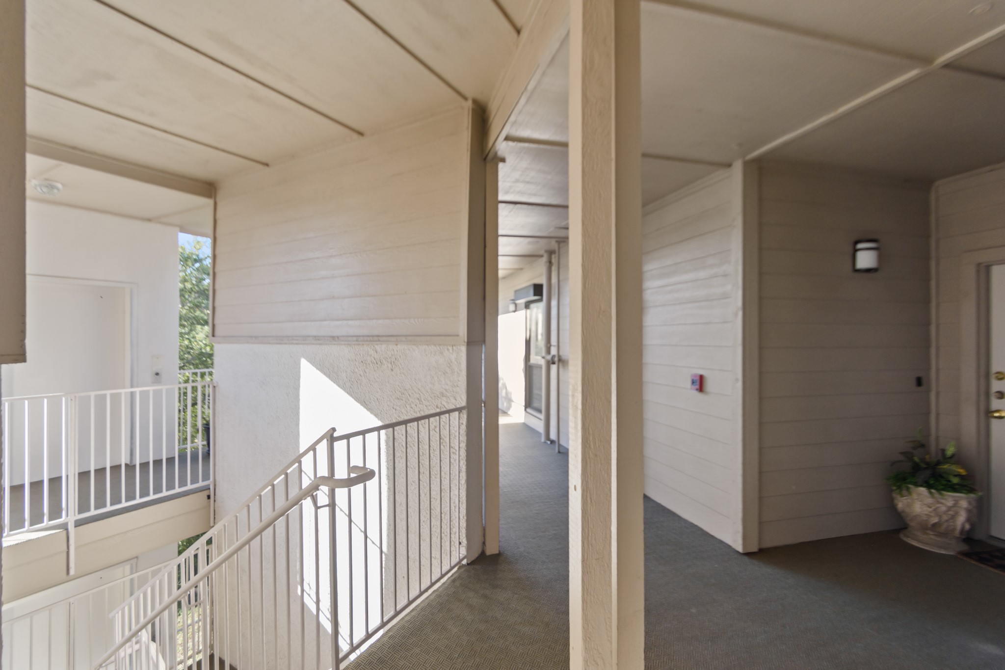 351 Lakeside Lane, Unit 305 Nassau Bay, TX 77058 - Photo 24 of 32 a view of a hallway to a room with wooden floor and stairs