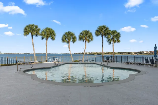 a view of a swimming pool with outdoor seating