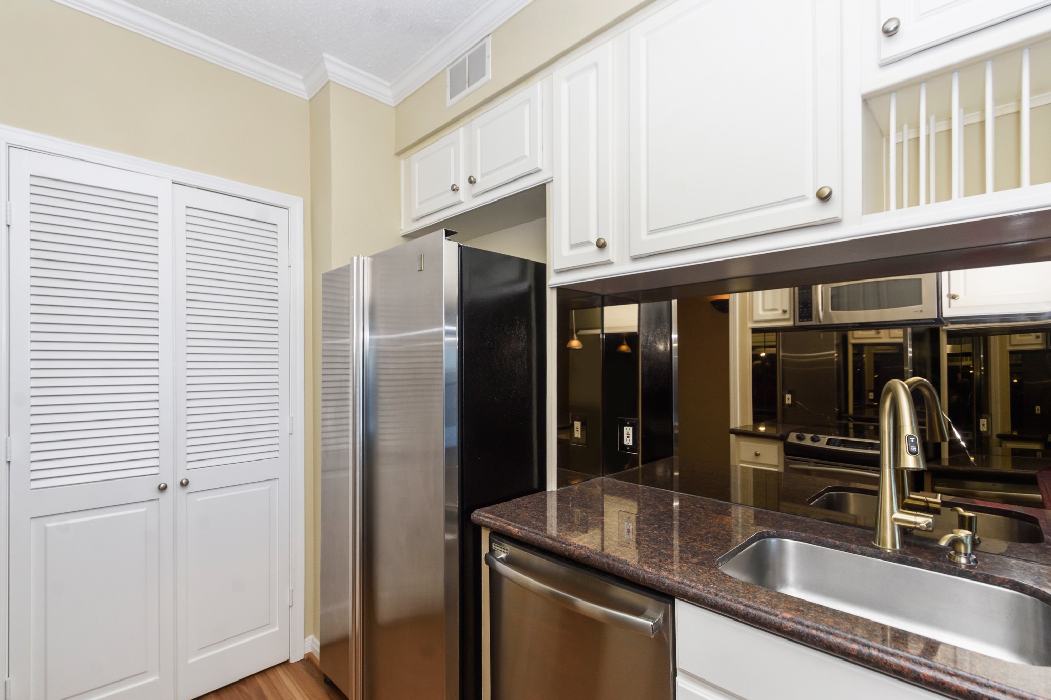 351 Lakeside Lane, Unit 305 Nassau Bay, TX 77058 - Photo 10 of 32 a kitchen with stainless steel appliances granite countertop a sink and a refrigerator