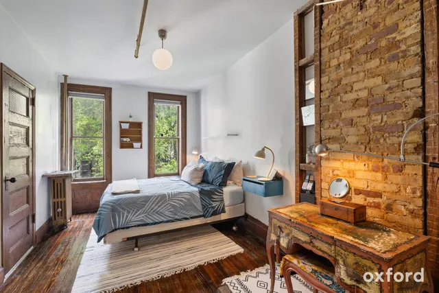 a kitchen with kitchen island a large counter top space appliances and a window