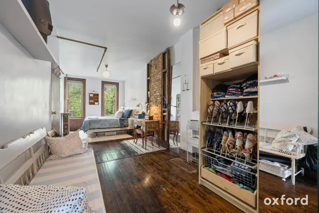 a bedroom with a bed and wooden floor
