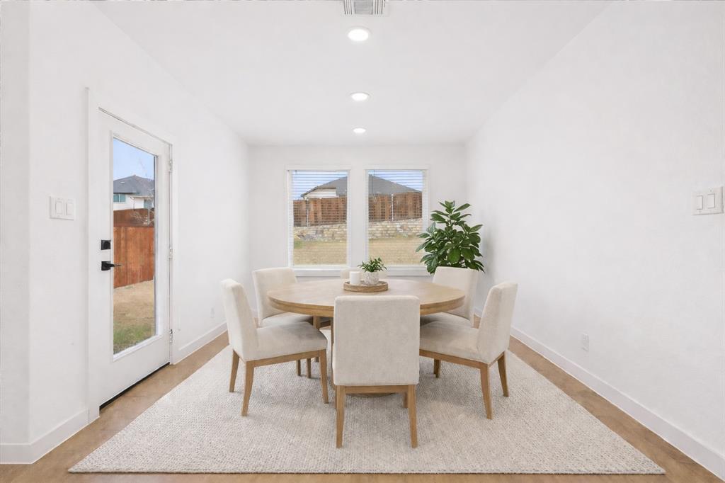 7136 Intrepid Drive Fort Worth, TX 76179 - Photo 12 of 31 a view of a dining room with furniture and wooden floor