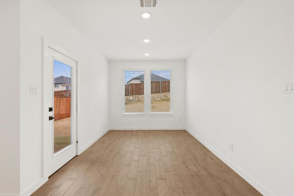 7136 Intrepid Drive Fort Worth, TX 76179 - Photo 13 of 31 an empty room with wooden floor and windows