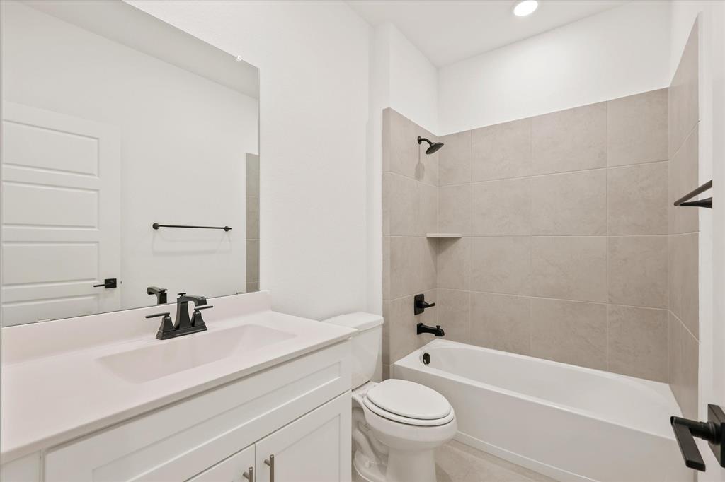 7136 Intrepid Drive Fort Worth, TX 76179 - Photo 14 of 30 a bathroom with a sink a toilet and shower