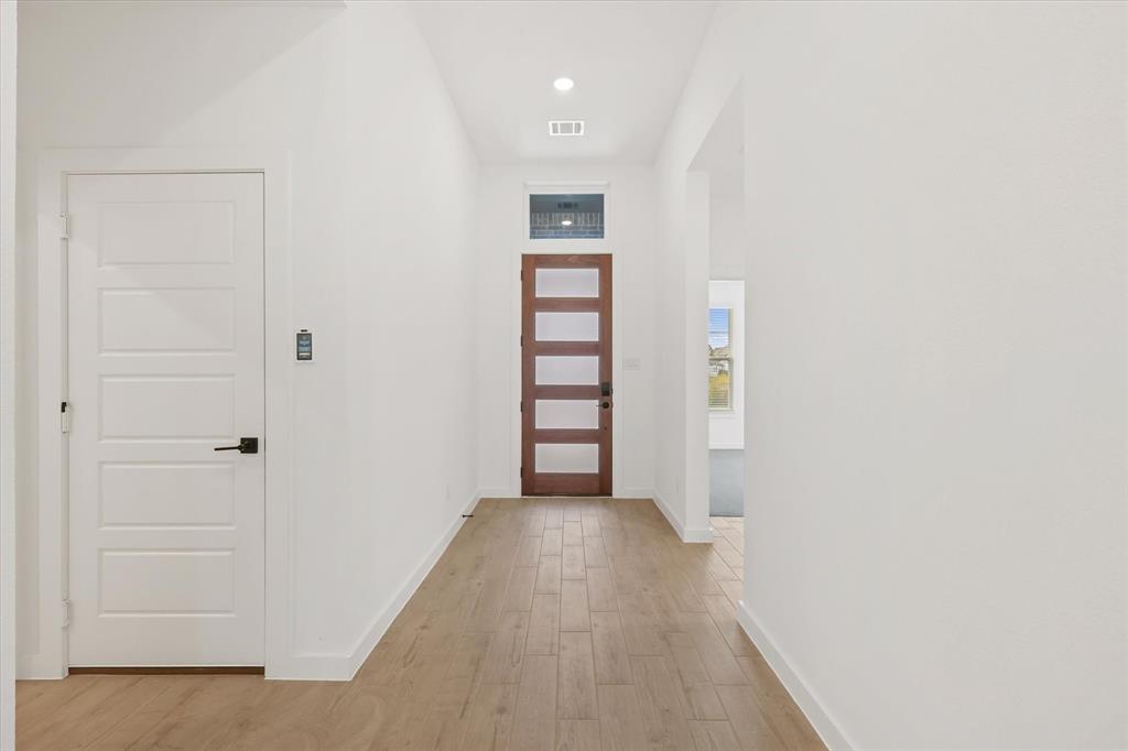 7136 Intrepid Drive Fort Worth, TX 76179 - Photo 5 of 30 a view of a hallway with wooden floor and entryway