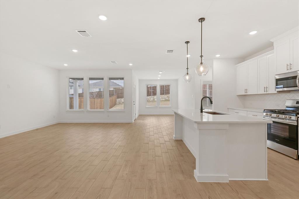 7136 Intrepid Drive Fort Worth, TX 76179 - Photo 6 of 30 a view of kitchen with stainless steel appliances granite countertop refrigerator sink and stove
