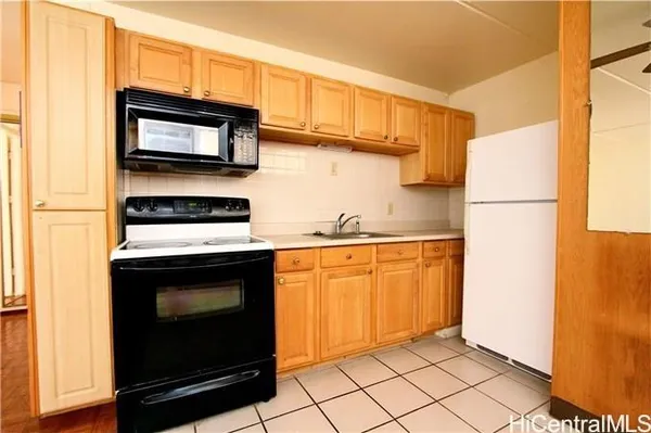 a kitchen with stainless steel appliances a stove a microwave and a refrigerator