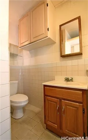 a bathroom with a sink toilet and a mirror