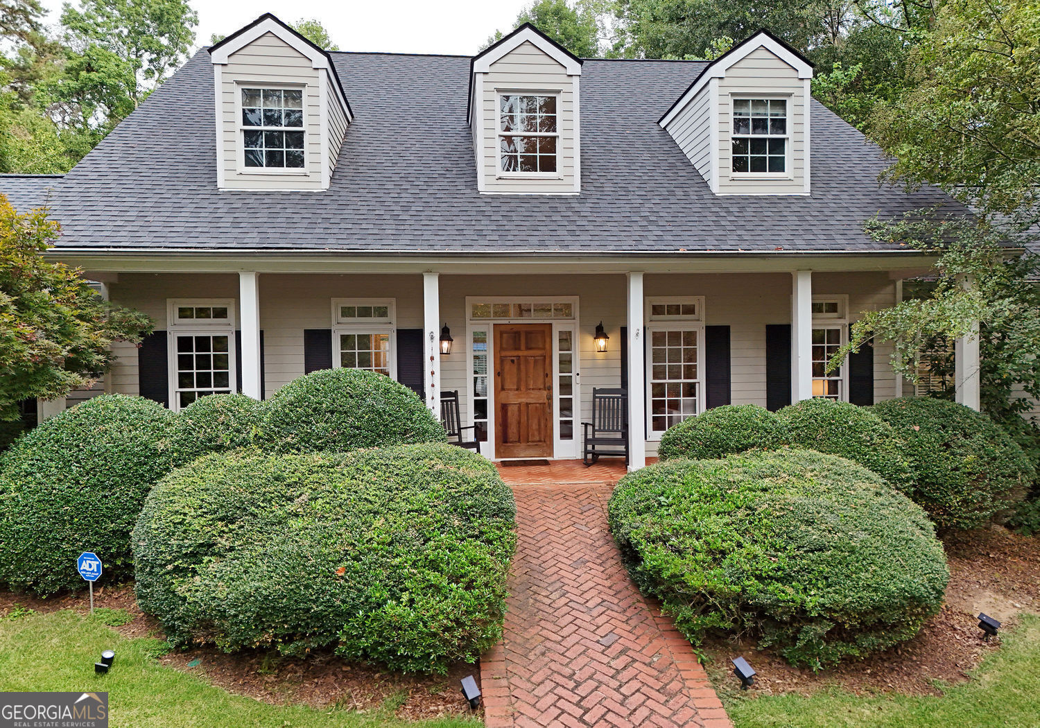 front view of a house with a garden