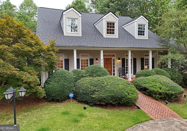 a front view of a house with a garden