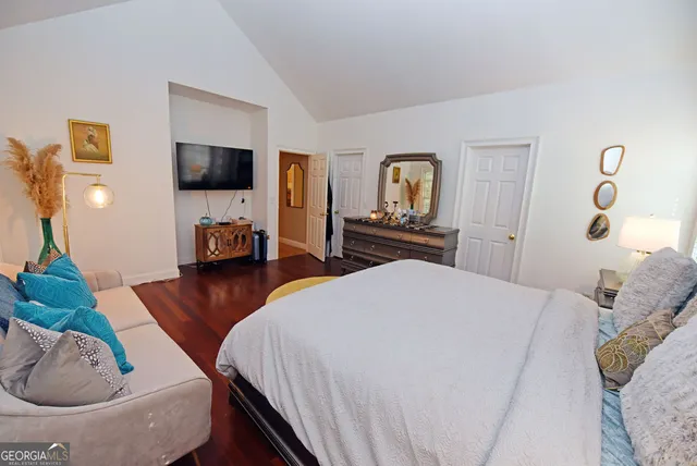 a view of a livingroom with wooden floor and staircase