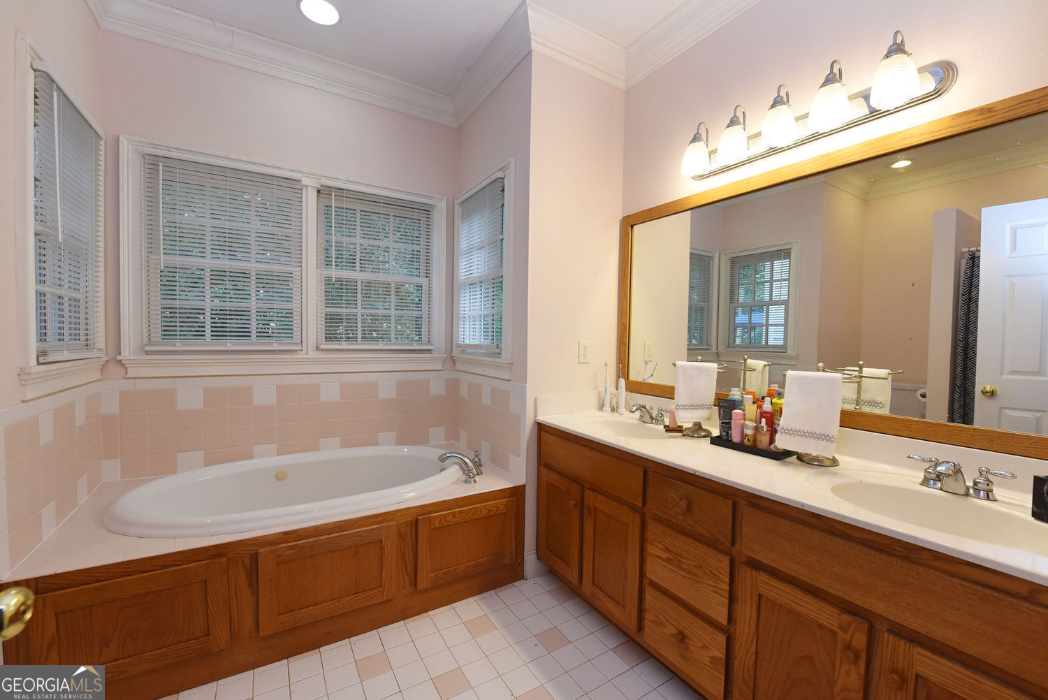 919 Deer Chase Toccoa, GA 30577 - Photo 26 of 62 a bathroom with a tub double sink window and mirror