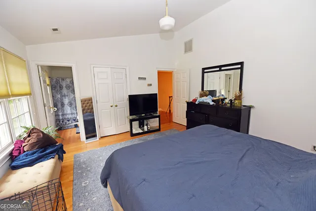 a bed sitting in a bedroom next to a window