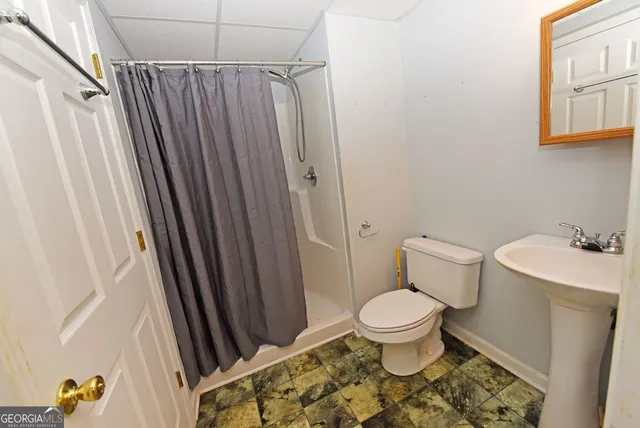 a view of a house with a backyard and sitting area