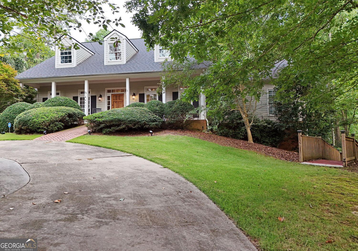919 Deer Chase Toccoa, GA 30577 - Photo 52 of 62 a view of a yard in front of a brick house with plants and large trees
