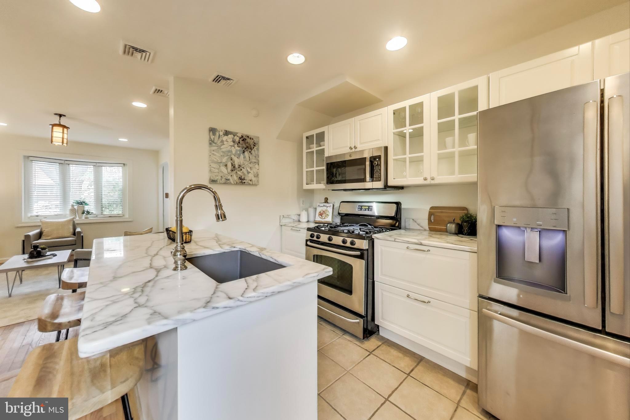3357 Clay Place Northeast Washington, DC 20019 - Photo 5 of 16 a kitchen with kitchen island a sink stainless steel appliances and cabinets