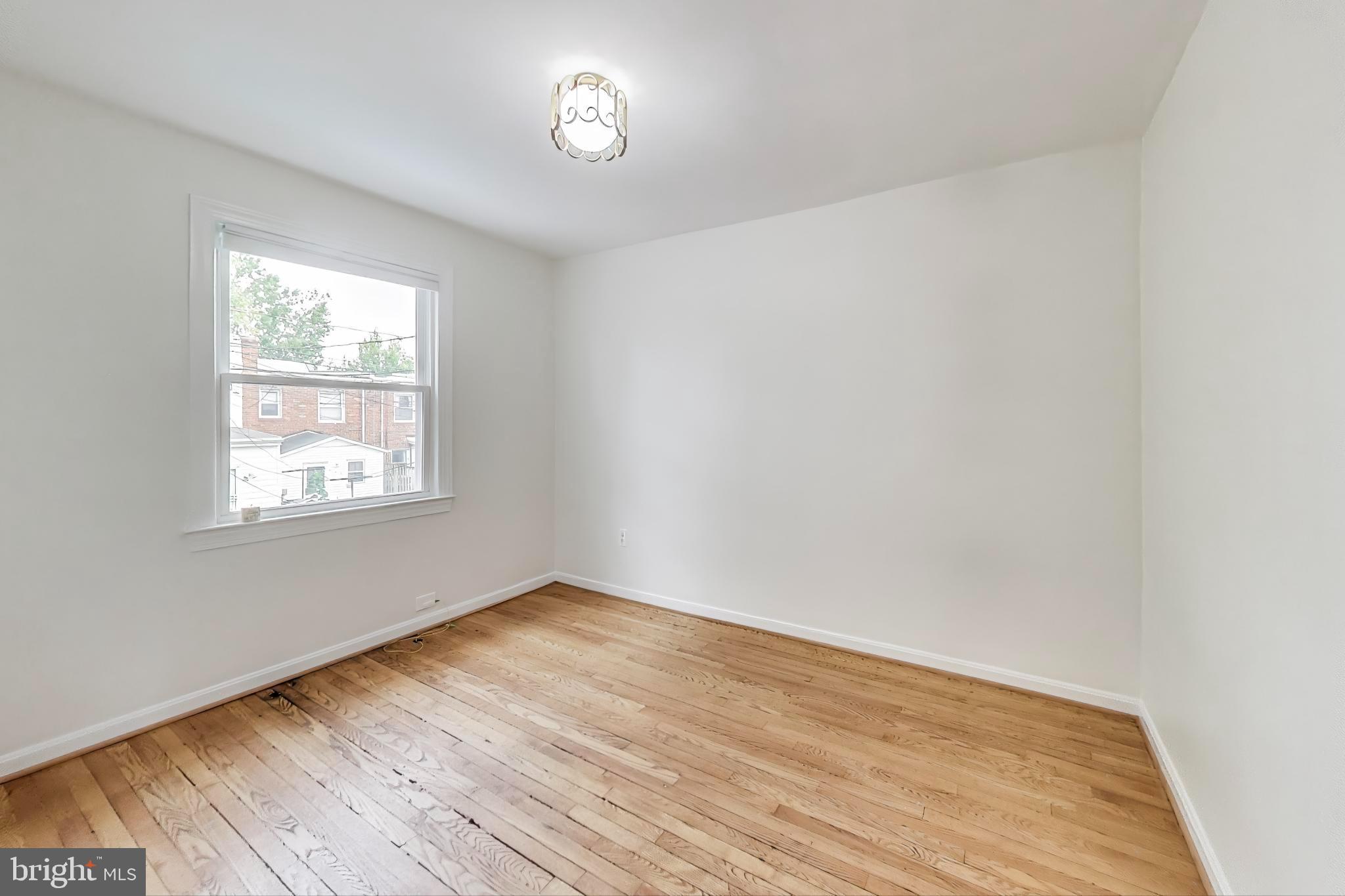 3357 Clay Place Northeast Washington, DC 20019 - Photo 9 of 16 wooden floor in an empty room with a window
