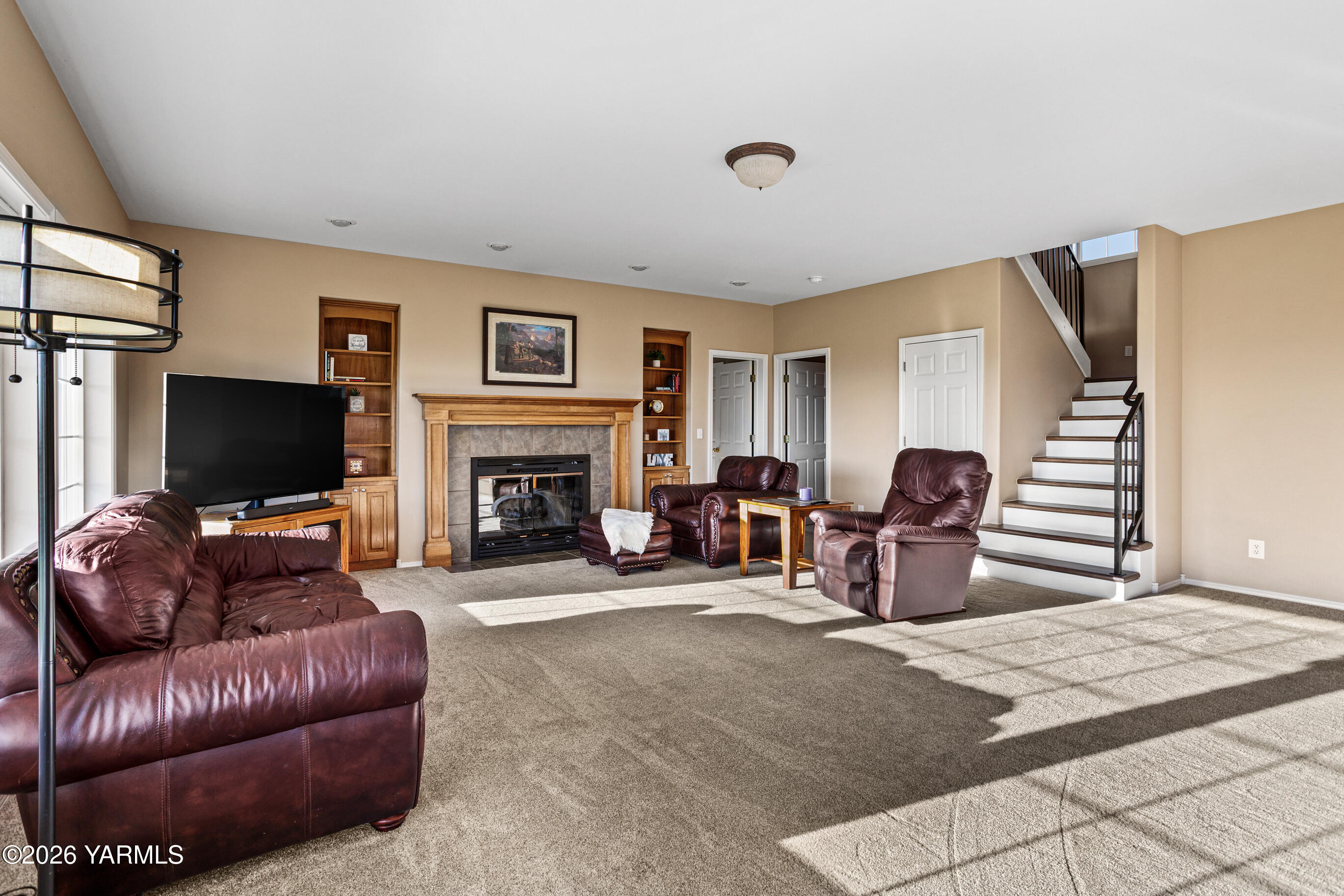 5060 Lombard Loop Road Zillah, WA 98953 - Photo 18 of 65 a living room with furniture a flat screen tv and a fireplace