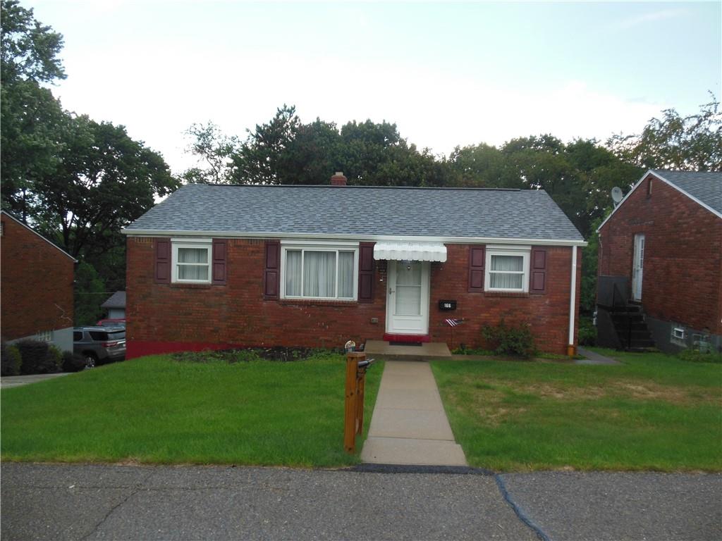 166 Castle Road Pittsburgh, PA 15234 - Photo 1 of 14 a front view of a house with a yard