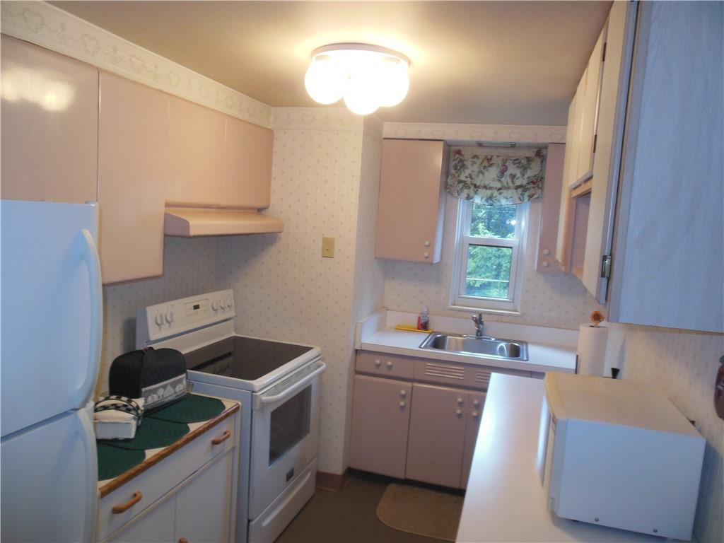 166 Castle Road Pittsburgh, PA 15234 - Photo 6 of 14 a kitchen that has a sink and a stove in it