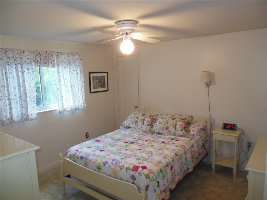 166 Castle Road Pittsburgh, PA 15234 - Photo 7 of 14 a bedroom with a bed and a chandelier