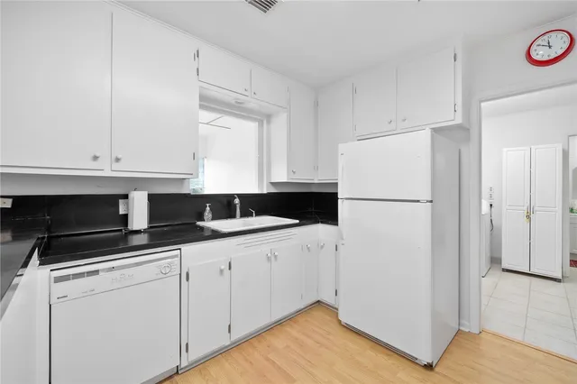 a kitchen with a sink and a refrigerator