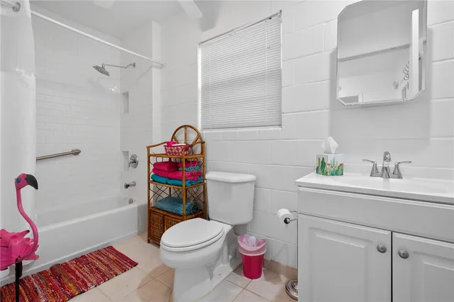 a white toilet sitting next to a bathroom sink