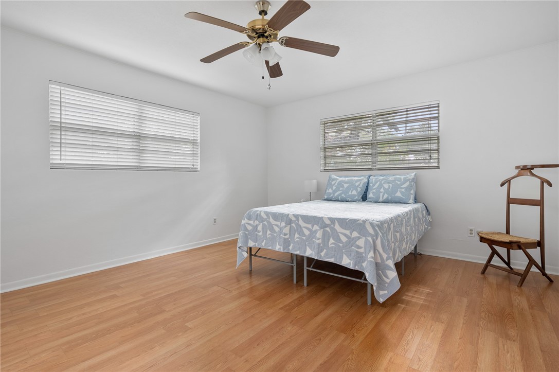 302 Fulton Avenue Rockport, TX 78382 - Photo 17 of 34 a bedroom with a bed and wooden floor