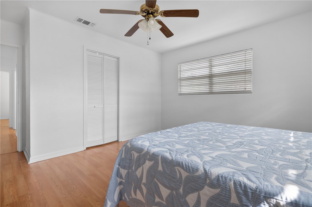 302 Fulton Avenue Rockport, TX 78382 - Photo 18 of 34 a bedroom with a bed and a chandelier