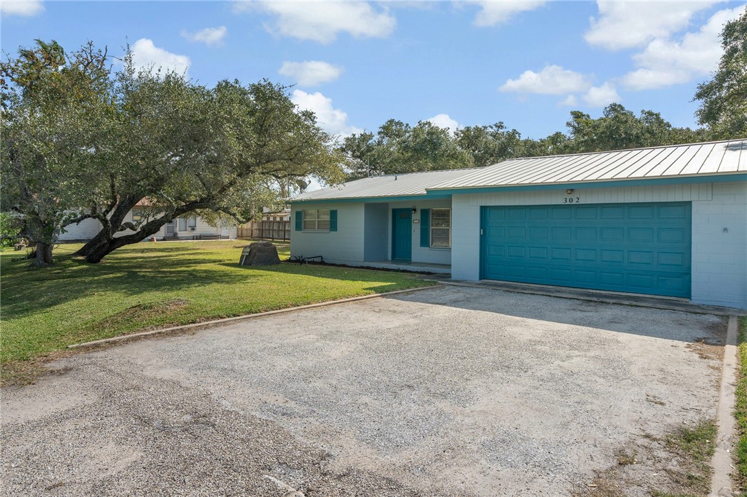 302 Fulton Avenue Rockport, TX 78382 - Photo 2 of 34 a view of a house with a yard and garage