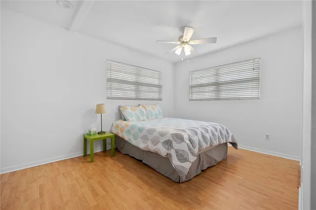 a spacious bedroom with a bed and a chandelier
