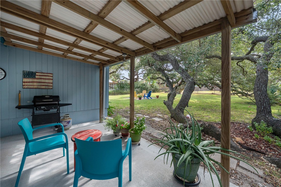 302 Fulton Avenue Rockport, TX 78382 - Photo 24 of 34 a dining room with furniture and a garden view