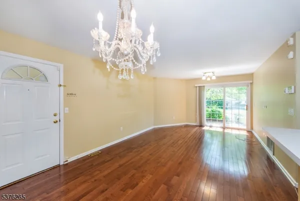 a view of livingroom with chandelier and wooden floor