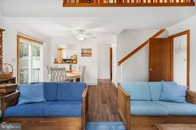 a living room with furniture and a dining table
