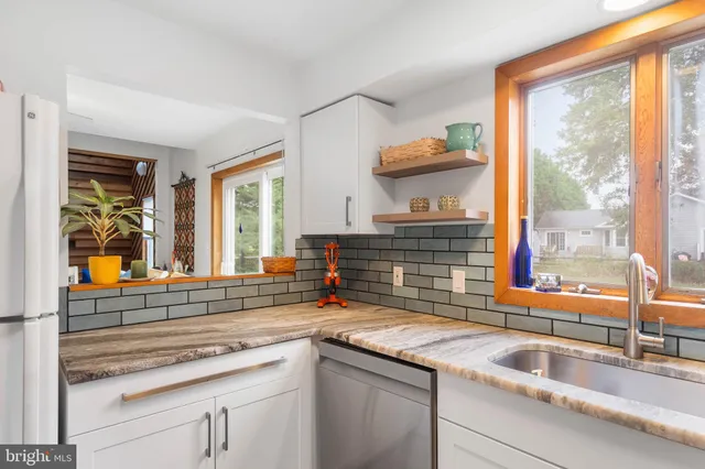 a white refrigerator freezer sitting inside of a kitchen