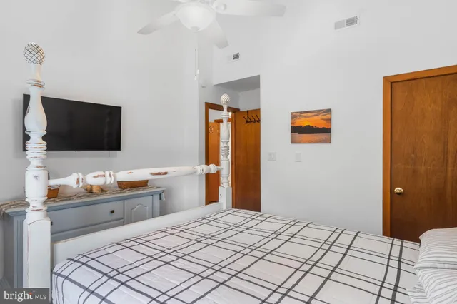 a bedroom with bed and a chandelier