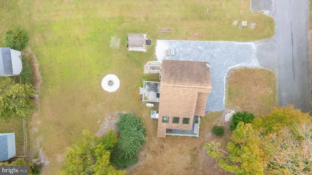 an aerial view of residential houses with yard