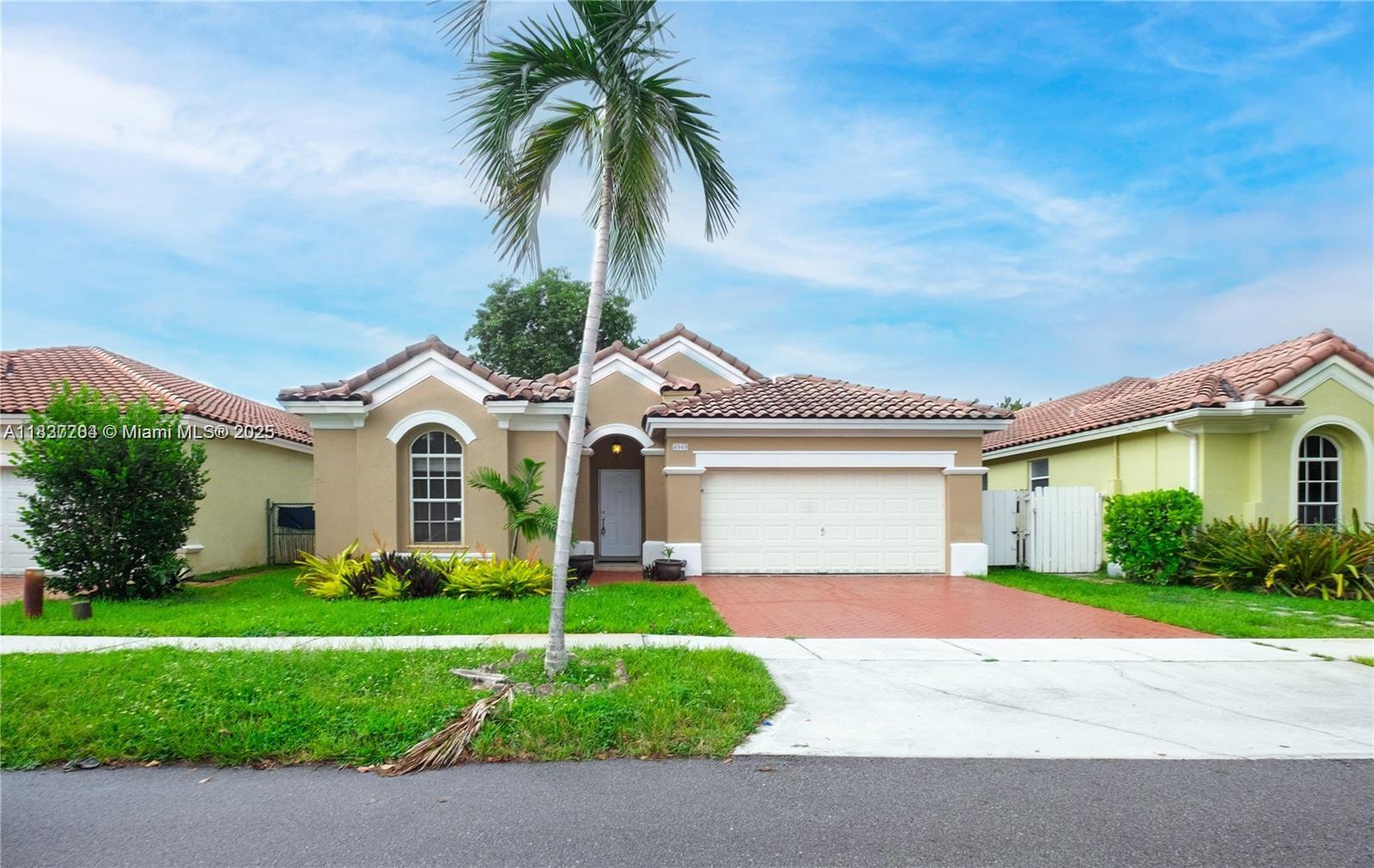 Miramar Patio Homes Miramar, FL 33027 - Photo 1 of 43 a front view of house with yard and green space