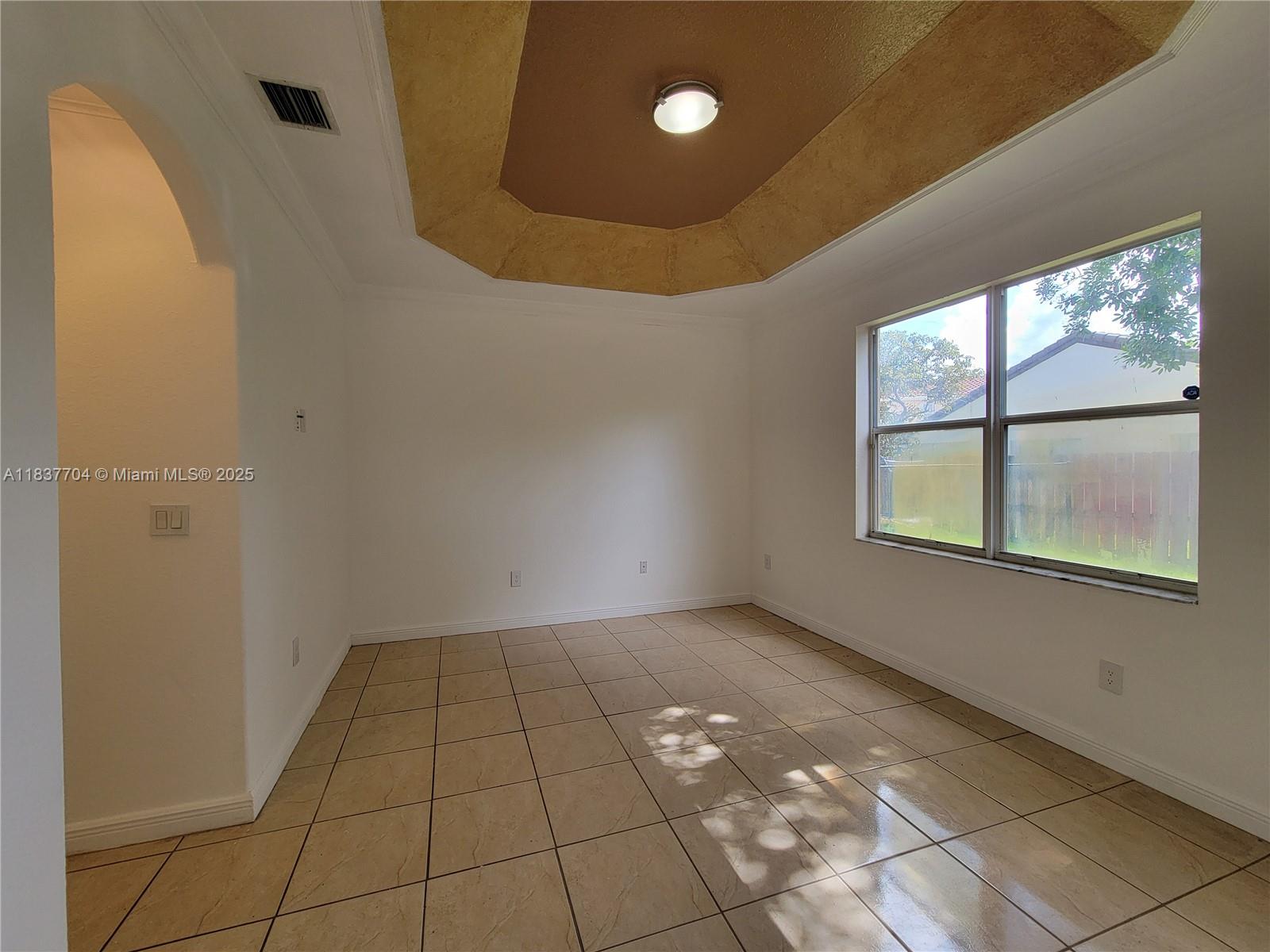 Miramar Patio Homes Miramar, FL 33027 - Photo 30 of 43 a view of an empty room with a window