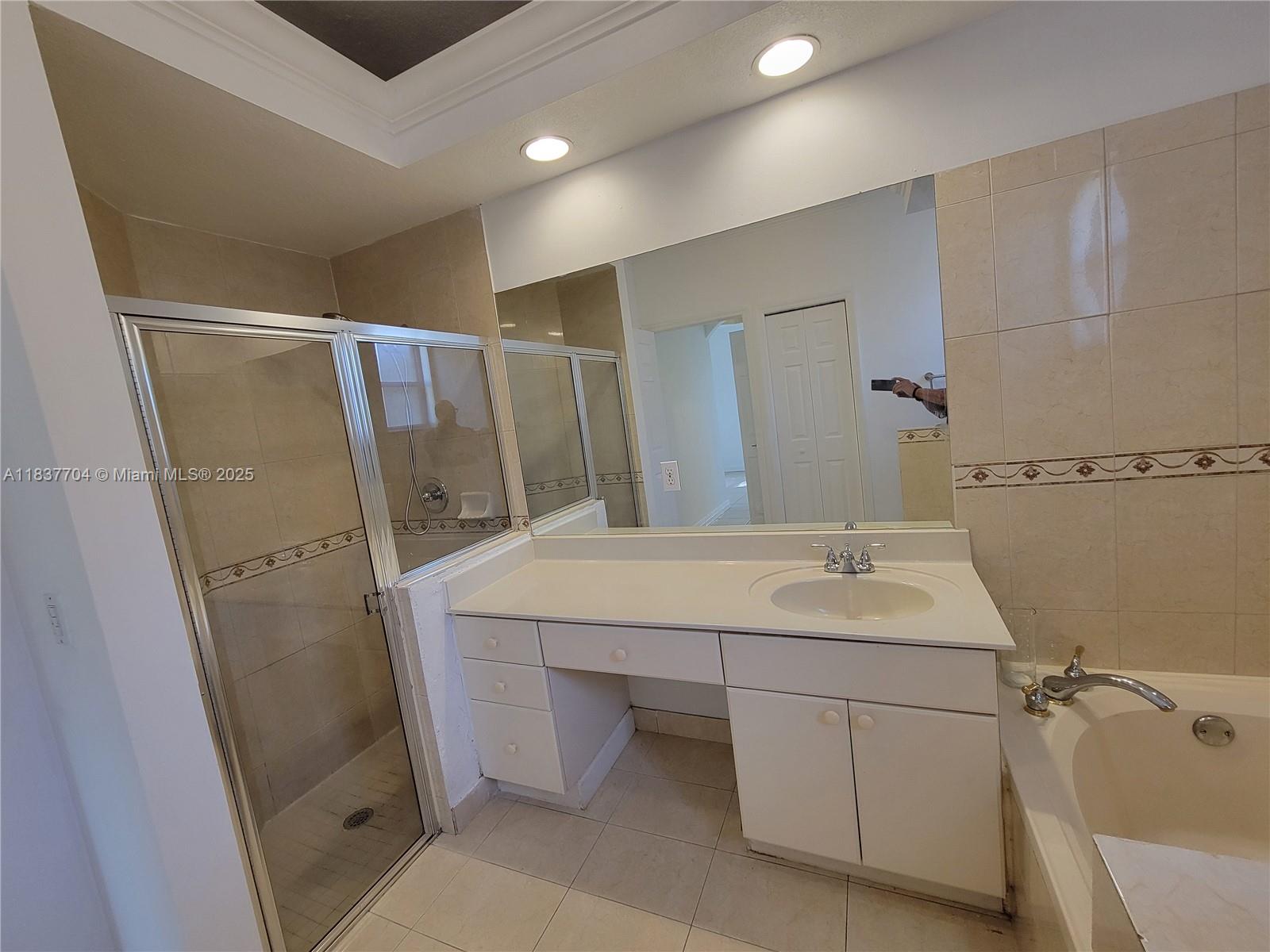 Miramar Patio Homes Miramar, FL 33027 - Photo 37 of 43 a bathroom with a sink and mirror